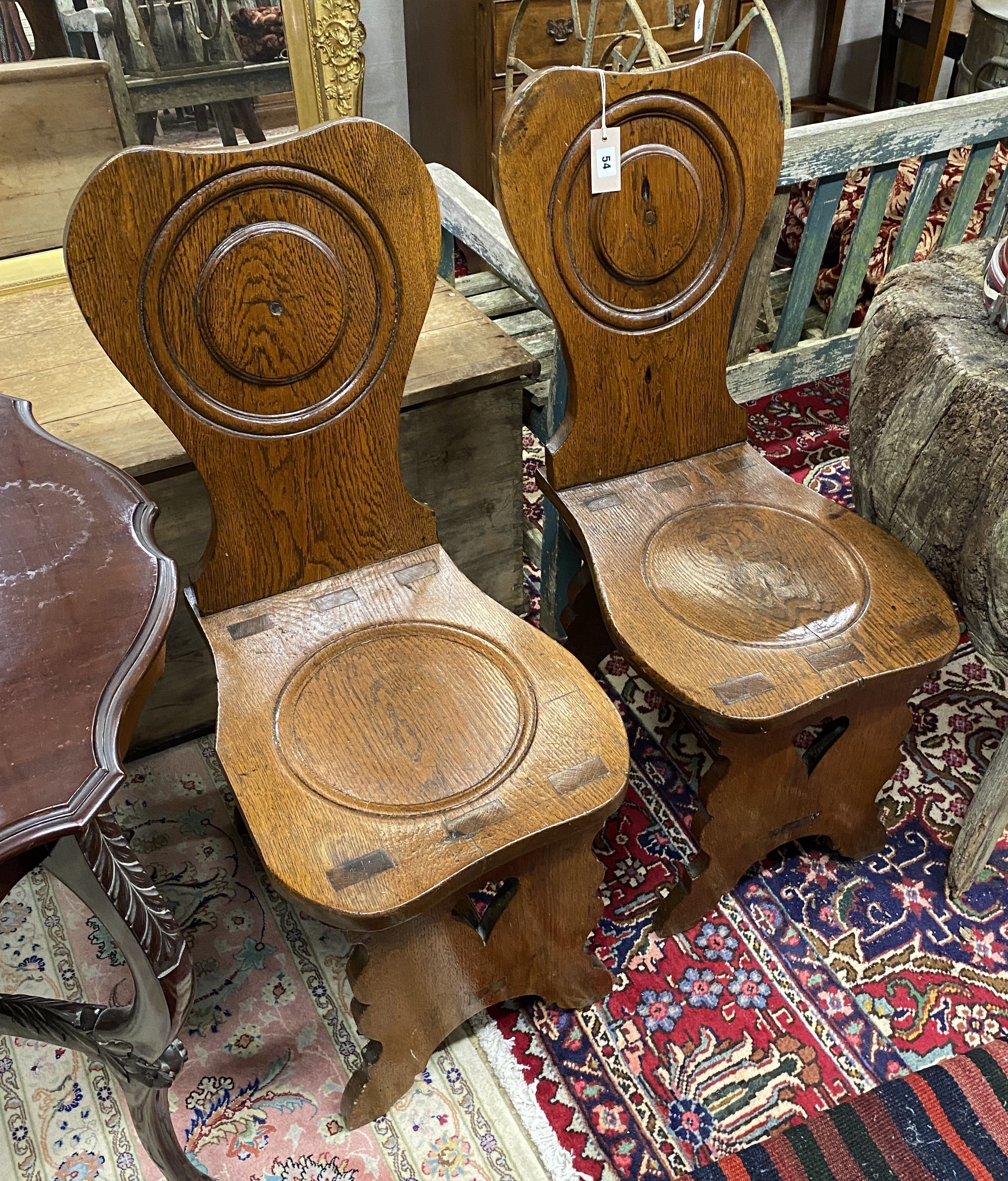 A pair of 18th century style Italian oak hall chairs, width 38cm, depth 50cm, height 91cm